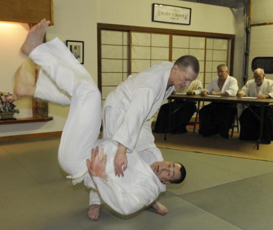 Serguei Vassiliev, who is blind, tests for his black belt in aikido, throwing opponent John Murphy to the ground.