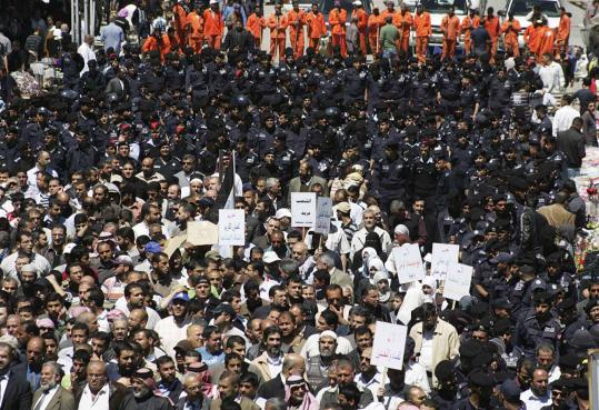 Police tried to separate antigovernment protesters from government supporters after prayers yesterday in Amman, Jordan.