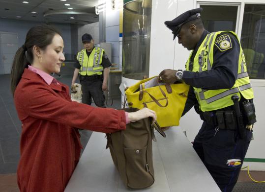 Transit Police Officer Jerry Antoine inspected Corinne Ng’s bags at the Aquarium T Station.