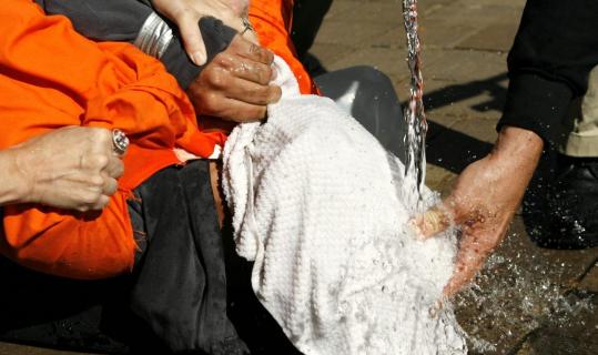 Demonstrator Maboud Ebrahimzadeh is held down during a simulation of waterboarding outside the Justice Department in Washington.