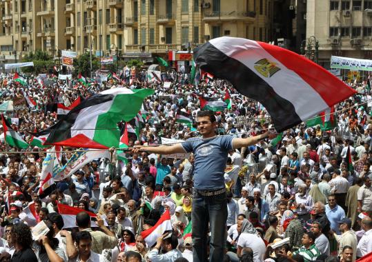 A demonstrator waved Egyptian and Palestinian flags during a national unity protest in Cairo’s Tahrir Square earlier this month.