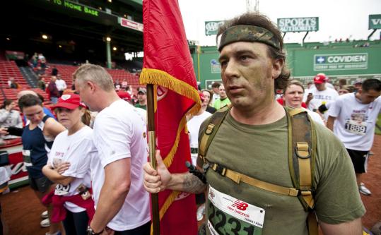 Newton firefighter and Marine veteran Chris Lessard was at Fenway Park with other runners after finishing yesterday’s race. More than 2,000 runners took part in the second annual event.