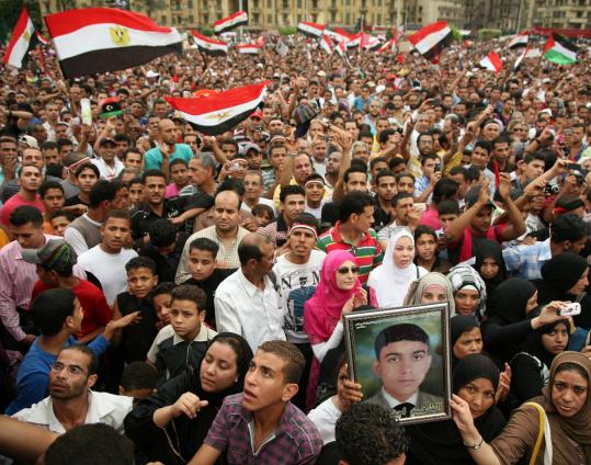 Protesters waved Egypt’s flag in Tahrir Square yesterday during a demonstration against military rulers over the pace of democratic reforms in their country.