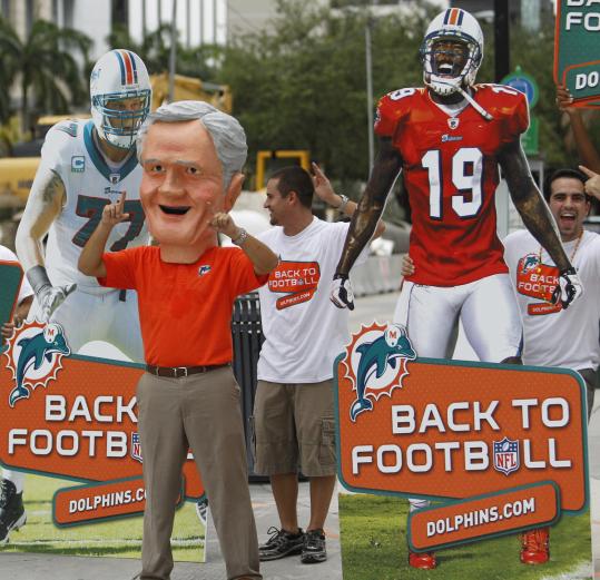 Employees and volunteers for the Dolphins, including one dressed as ex-coach Don Shula, celebrate the end of the lockout.