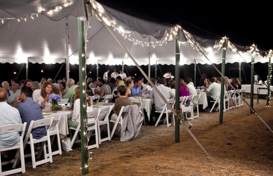 Guests dine under a tent at a recent “Whim Dinner’’ at Smolak Farms in North Andover.