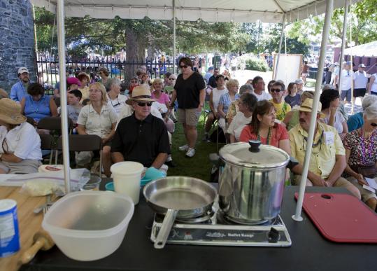 The audience for the food demonstrations Saturday at the Lowell Folk Festival were shown how to make various ethnic noodle dishes.
