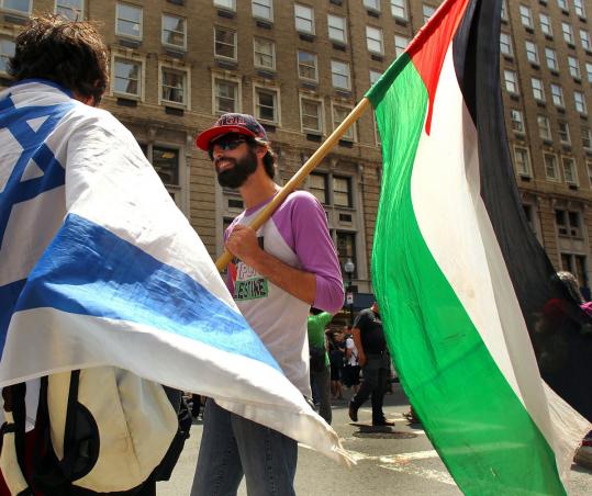 A pro-Israeli demonstrator talks with a pro-Palestinian demonstrator outside the Israeli consulate in Boston.