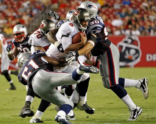 Patriots linebackers Jerod Mayo (left) and Rob Ninkovich converge on Buccaneers quarterback Josh Freeman. Mayo finished with a pair of sacks.