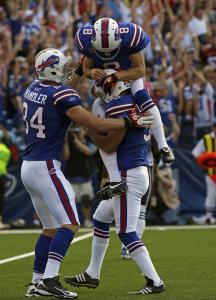 Brian Moorman, the holder on Rian Lindell’s winning field goal, jumps on Lindell to celebrate.
