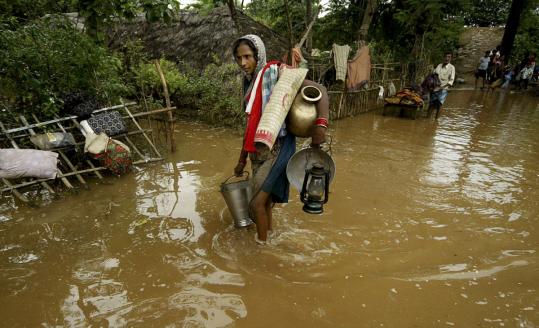 A woman waded through flood waters, making her way back to her village in Orissa’s Jajpur district, one of several areas in northern and eastern India hit by monsoon rains.