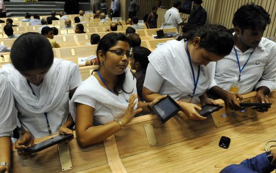 Students in India used the inexpensive Aakash computer tablet introduced yesterday in New Delhi. Developer Datawind is selling the tablets to the government for about $45 each, and subsidies will reduce that to $35 for students and teachers.