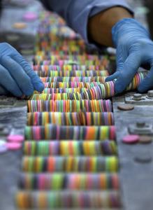A worker sorted Necco Wafers for packaging. Each roll contains a mix of the candy’s eight flavors.