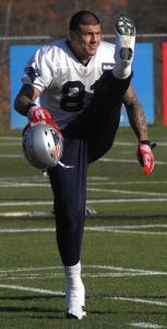 Patriots tight end Aaron Hernandez kicks up his stretching routine a notch before practice.