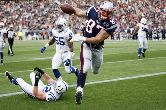 Rob Gronkowski avoids the Colts’ A.J. Edds (52) after leaving Ernie Sims (55) behind, scoring his third TD of the game.