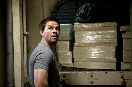 Mark Wahlberg spends much of his time in “Contraband’’ on a barge trying to bring counterfeit cash into New Orleans.