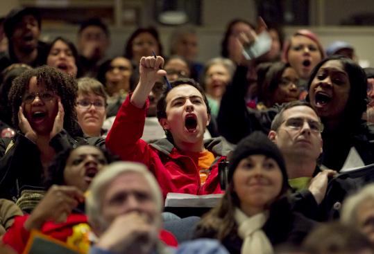 People at a public hearing at the Boston Public Library's main branch tonight booed when the MBTA showed its proposed service cuts and fare increases on a projection screen.