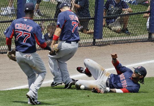 Despite the efforts of Red Sox Pedro Ciriaco, Nate Spears, and Darnell McDonald, a single by Tampa Bay’s Jose Lobaton falls in safely during the third inning.