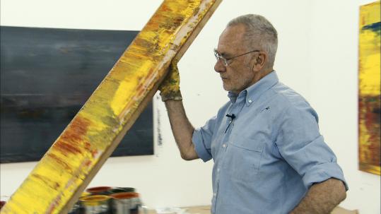 Artist Gerhard Richter in one of his studios that are all white walls and floors.