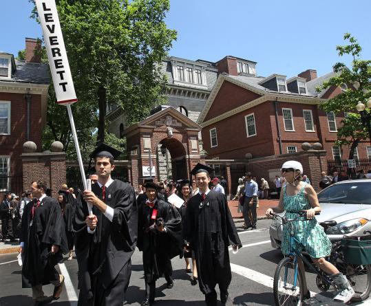 Harvard graduates, class of 2012, marched across Massachusetts Avenue Thursday.