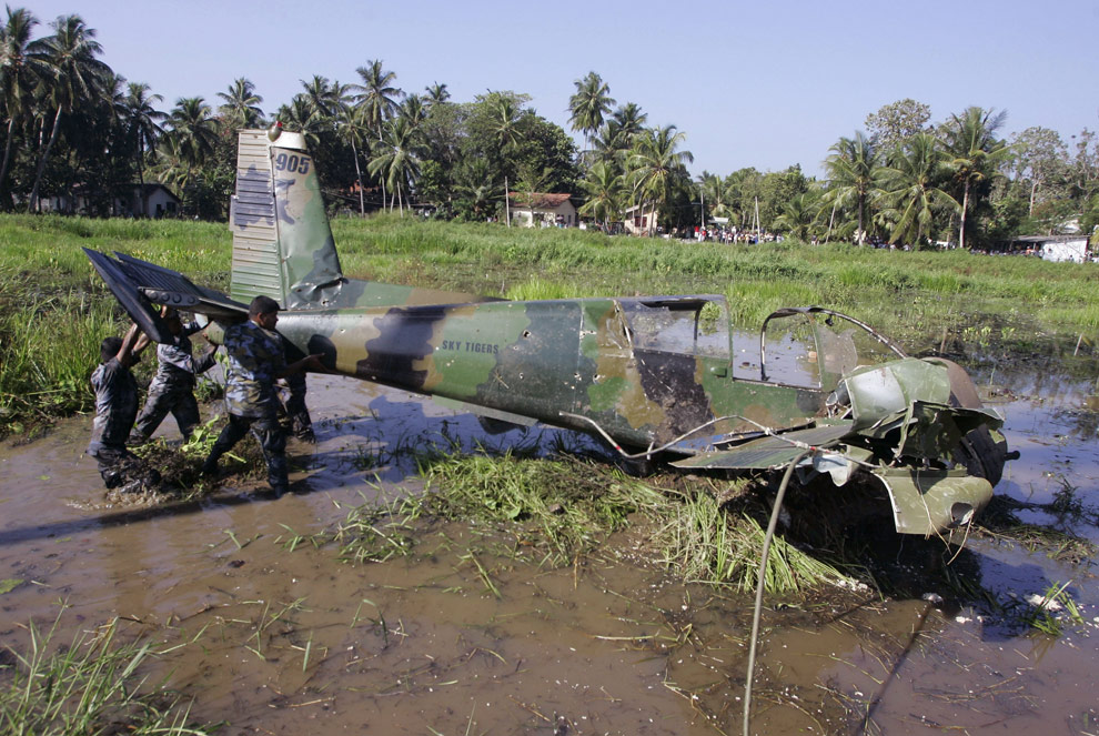 Sri Lankan air force officers lift the wreckage of 