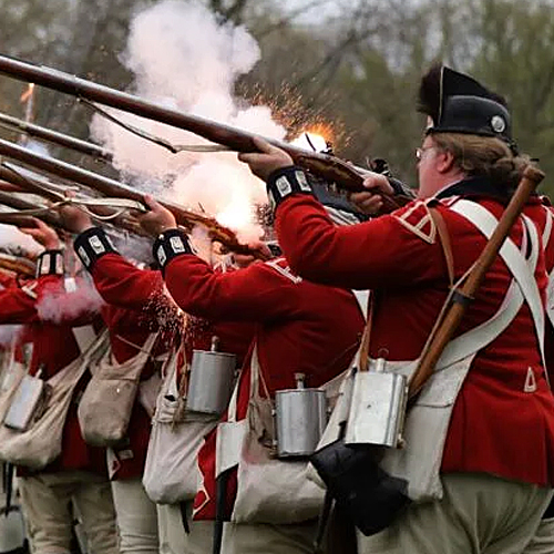The British Regulars fired their muskets during the re-enactment of the Battle of Lexington on the town green in April 2023.