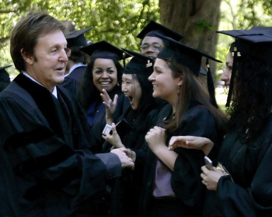 Paul McCartney shakes hands with graduating seniors as he takes part in commencement ceremonies yesterday at Yale University.
